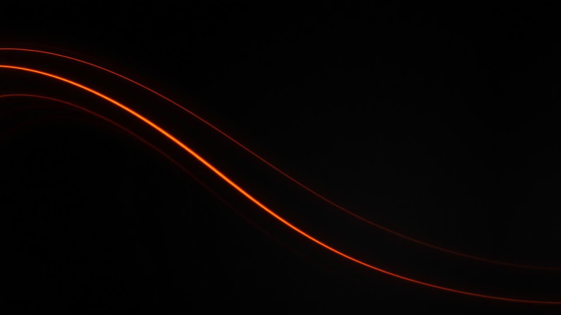 Abstract orange light streaks on a dark background